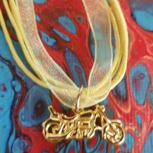 Gold tone motorcycle charm pendant